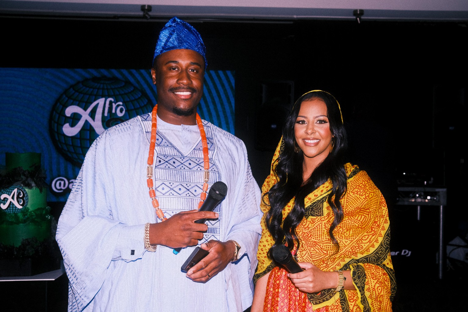 Daniel Olasoji and a co-host dressed for a cultural event