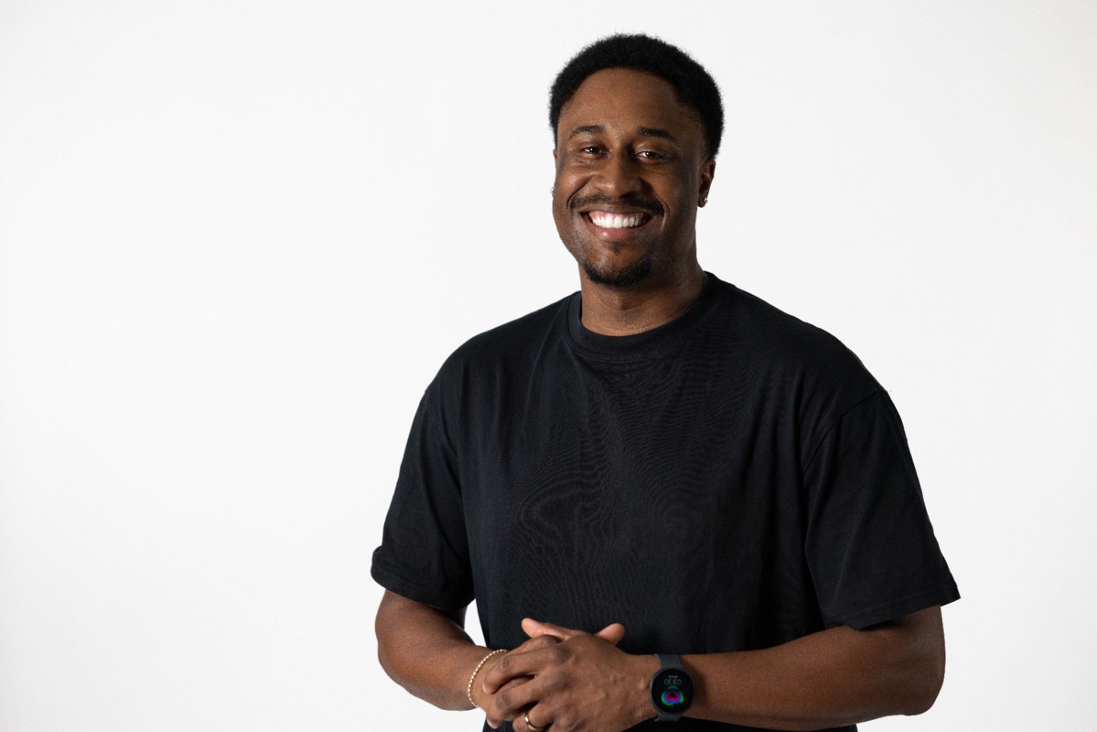 Daniel Olasoji smiling in a studio portrait